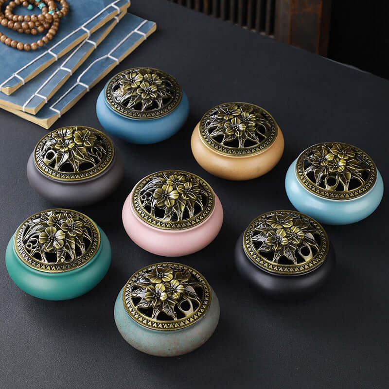 Ceramic Buddha Incense Burner with antique copper lid and smoke, perfect for meditation and calming spaces.