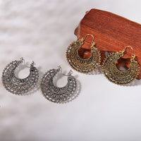 Gold retro mandala earrings displayed in their jewelry packaging