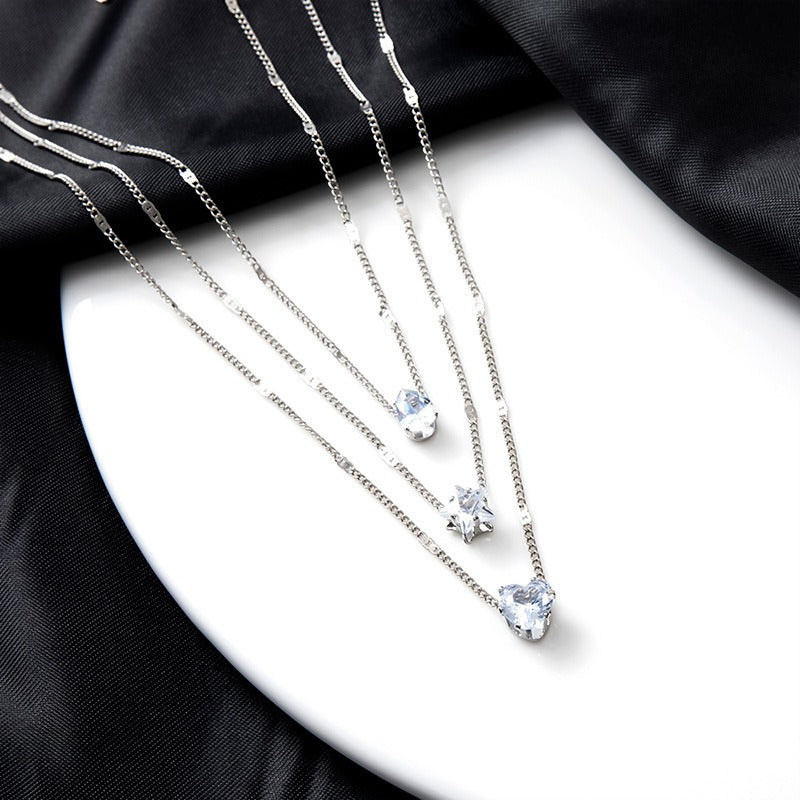 Layered Pendant Necklace Set featuring silver heart and star charm layers