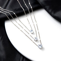 Layered Pendant Necklace Set featuring silver heart and star charm layers