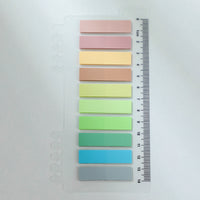 Sticky note index tabs used as page markers in a notebook