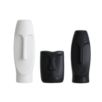 Nordic face-art ceramic vase shown in white and black colorways, in two sizes