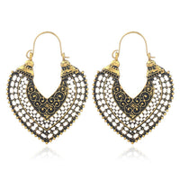 Gold mandala floral earring shown from a side angle