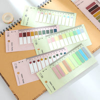 Assorted rainbow sticky note index tabs laid out for bookmarking pages