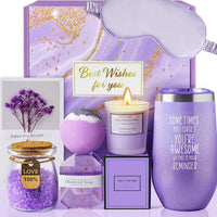 Contents of the pink and purple spa gift set laid out, including bath salts and dried flowers