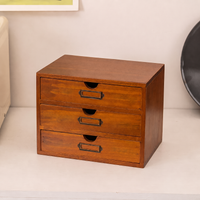 Solid wood three-drawer desktop storage organizer with dark metal handles, front angle view
