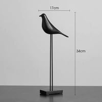 Modern minimalist bird figurines styled with books and decor accessories