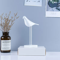 Modern minimalist bird figurine displayed on a plain background